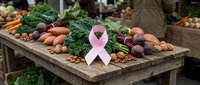 Fresh organic vegetables and pink awareness ribbon on rustic wooden table at farmers market promoting healthy eating and cancer prevention lifestyle.