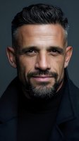Handsome mature Hispanic man with beard and styled hair wearing black jacket, confident expression for business and lifestyle concepts.