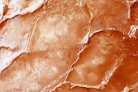 Macro view of pink Himalayan salt crystal surface showing natural mineral formations and crystalline patterns in warm copper tones. Suitable for food industry.