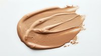 Creamy beige foundation makeup smear with smooth texture isolated on white background for cosmetic and beauty product design applications.