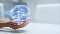 Digital holographic brain floating above open palm representing artificial intelligence, neuroscience, mental health, cognitive science and futuristic technology concepts.