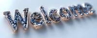 Decorative welcome sign with blue crystals and metallic rose gold finish, elegant dimensional lettering creates sparkly greeting display for home or business entrance.