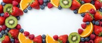 Fresh mixed berries and citrus fruits arranged in colorful border frame on white background for healthy eating and nutrition concepts.