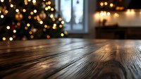 Rustic wooden table surface with blurred Christmas tree lights and bokeh in background creating festive holiday atmosphere for product display or celebration.