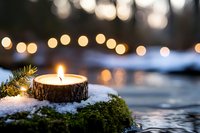 Rustic wooden candle glowing on snowy moss with warm bokeh lights creating cozy winter atmosphere for holiday decorating and seasonal celebrations.