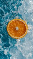 Fresh orange slice on crushed ice with splashing water against turquoise background, creating dynamic contrast for beverage and food photography.
