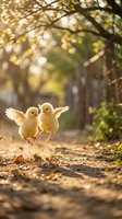 Two yellow chicks with wings spread walking on a dirt path under a tree-lined avenue with dappled sunlight filtering through foliage, suitable for spring and Easter themes.