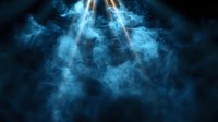 Dramatic rays of light pierce through swirling blue smoke against dark background creating atmospheric mystical effect. Suitable for spiritual and theatrical backgrounds.