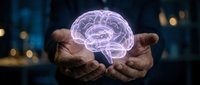 Glowing purple brain hologram floating above cupped hands against dark background with bokeh lights for medical technology and neuroscience concepts.