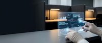 Medical professional using futuristic holographic interface technology in modern laboratory environment for digital healthcare innovation and research.