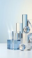 Transparent glass geometric shapes and crystal spheres arranged in minimalist composition against soft gradient background, suitable for luxury branding and cosmetics packaging design.