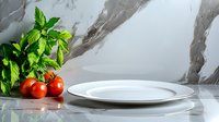 Fresh red cherry tomatoes and green basil leaves next to white ceramic plates on marble surface with dramatic lighting and reflections, food photography setup.