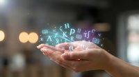 Woman's hand holding glowing letters and symbols representing digital communication, data transfer, and technology innovation for business, education, and online learning concepts.