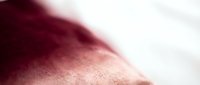 Close-up of smooth human skin with soft lighting creating gentle shadows and highlights, showcasing natural texture and warmth for skincare and beauty concepts.