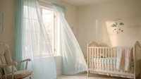 Serene nursery room with white wooden crib, soft mint curtains, natural light from window, and neutral decor for baby bedroom design and interior styling.