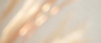 Soft blurred abstract background with warm beige and cream tones, diagonal light streaks creating dreamy bokeh effect for elegant design projects.