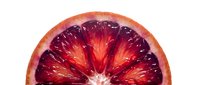 Sliced blood orange half showing deep red flesh and vibrant citrus interior, isolated on white background for food and beverage design projects.