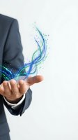 Businessman in dark suit holding hand with glowing blue and green digital wave particles flowing upward, representing technology, innovation, and data stream for business solutions.