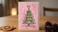 Handmade greeting card featuring decorated evergreen tree with heart topper on pink textured background, surrounded by dried citrus slices and pinecones for festive holiday or seasonal celebrations.