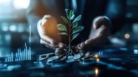 Young plant growing from coins with hands nurturing growth against financial chart background in blue tones, representing investment and wealth growth concept.
