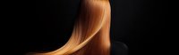 Smooth flowing golden blonde hair against dark background, showcasing silky texture and healthy shine for beauty salon advertising.