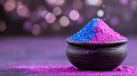Vibrant blue and pink powder pigments in rustic black bowl against purple bokeh background, artistic composition for cosmetics, festivals and color concepts.