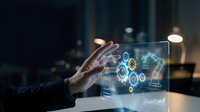 Businessman hand touching holographic gear interface with digital technology symbols and glowing blue circuit patterns for innovation, automation, and engineering concepts.