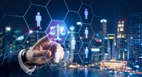 Professional businessman touching digital justice scales icon in hexagonal network interface against city skyline at night representing legal technology solutions.