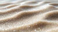 Shimmering golden waves of glitter and sparkles create mesmerizing abstract pattern on soft beige background with dreamy bokeh effect and gentle undulating texture.