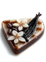 Heart-shaped chocolate candy with vanilla flowers decoration, coffee beans and dried vanilla pods on glossy brown surface, isolated on white background.