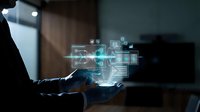 Businessman using laptop with holographic digital interface displaying data analytics charts and graphs in modern office environment at night.