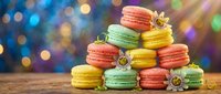 Colorful French macarons stacked in pyramid arrangement on wooden surface with festive bokeh lights background for celebrations and dessert displays.