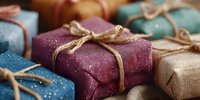 Colorful wrapped gift boxes with natural twine bows and sparkly paper for holidays, birthdays, and special celebrations.