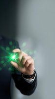 Hand holding glowing green star with light effects, representing innovation, energy, success and business growth concepts for corporate presentations.