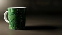 White ceramic mug with green circuit board pattern design on wooden surface for technology themed office decor and electronics enthusiasts.