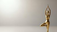 Golden yoga figurine in tree pose meditation stance on neutral background for wellness and mindfulness concepts.