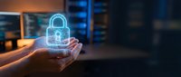 Hand holding glowing padlock hologram in server room environment, representing cybersecurity, data protection, and digital safety for technology and business applications.