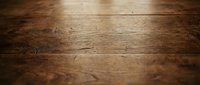 Rustic wooden floor planks with natural grain texture and warm brown tones creating atmospheric depth of field background for interior design projects.