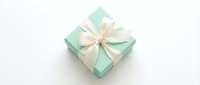 Mint green gift box with cream ribbon bow isolated on white background for holiday celebrations, birthdays, and special occasions packaging design.