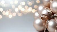 Elegant pearl white Christmas baubles with glittering champagne ribbon bow against soft bokeh background. Festive holiday decor with luxurious ornaments.