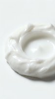 Creamy white cosmetic product with smooth, swirled texture on neutral background, suitable for skincare, beauty, and wellness marketing materials.