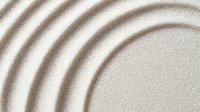 Concentric circles pattern drawn in light beige sand creates zen garden effect with smooth rippling waves and gentle gradients for spa and wellness designs.