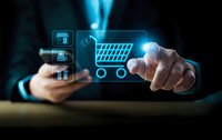 Businessman touching digital shopping cart icon with e-commerce symbols on futuristic holographic interface for online retail technology solutions.