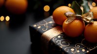 Fresh tangerines with golden bow on luxury black gift box with elegant gold pattern against dark background with bokeh lights for festive season.