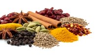 Colorful aromatic spices and herbs collection with turmeric powder, cinnamon sticks, star anise, cardamom pods, chili flakes on white background.
