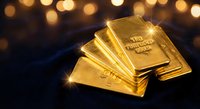 Golden bullion bars stacked with warm bokeh lights creating luxury investment and wealth concept for financial marketing materials.