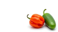 Fresh red and green hot chili peppers isolated on white background for cooking, spice ingredients, healthy organic vegetables and culinary design projects.