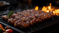 Juicy meat kebabs grilling on barbecue with rising smoke and flames in background. Fresh herbs and cherry tomatoes complement traditional Middle Eastern cuisine.
