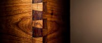 Close-up of traditional dovetail wood joint showing craftsmanship and precision in furniture making and carpentry work for woodworking projects.