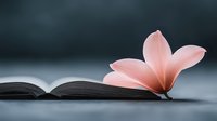 Delicate pink plumeria flower resting on open book pages against blurred dark background, creating peaceful minimalist composition for meditation and reading.